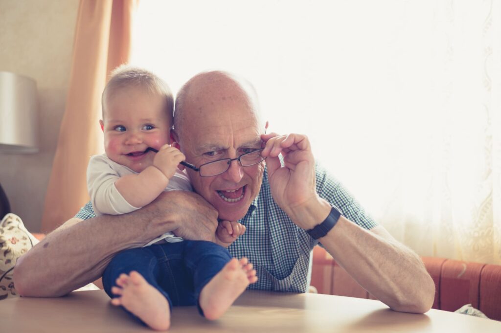 Grandfather Playfully Holding His Grandchild