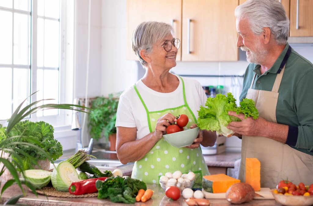 Senior couple preparing a healthy meal with fresh vegetables